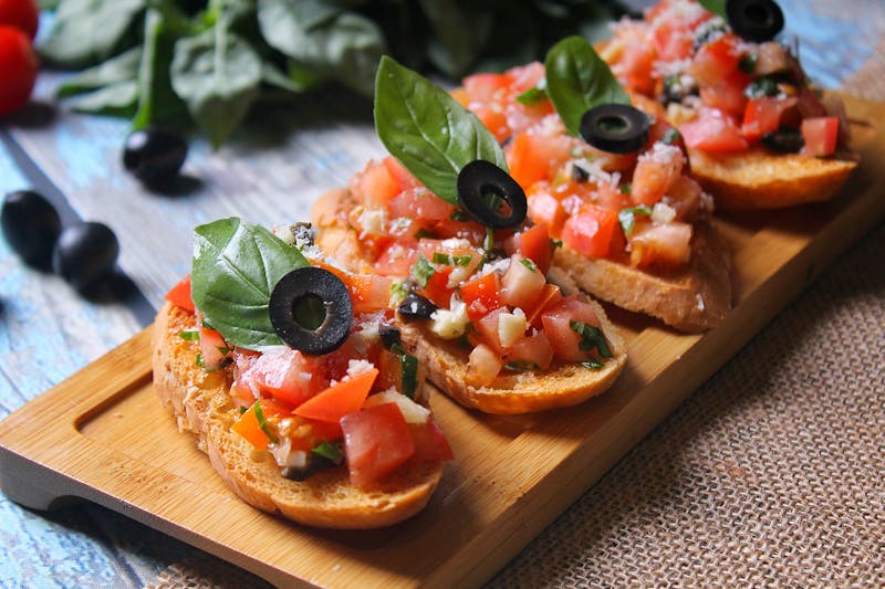 Bruschetta topped with tomatoes and basil